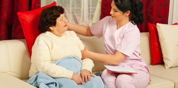 caregiver assists the elderly woman