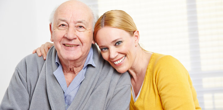 elderly man and a woman smiling